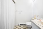 Ensuite bathroom featuring shower / tub combo 